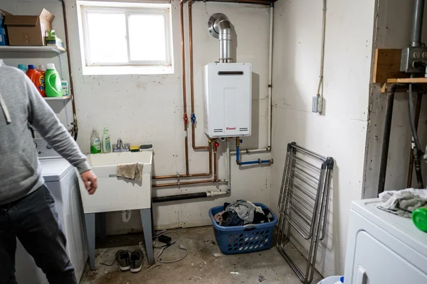 Compact wall-mounted tankless unit with isolation valves and concentric venting