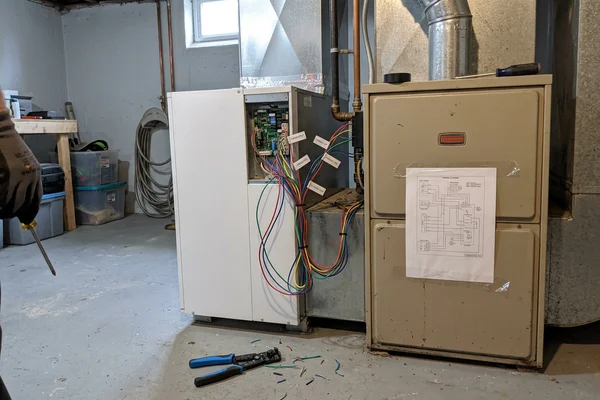 Indoor air handler paired with a gas furnace in a dual-fuel configuration